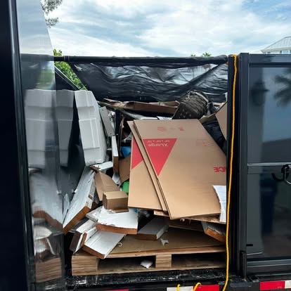 Trailer loaded with cardboard and wood