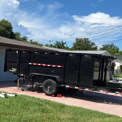 Mud Pit dump trailer parked on a paver driveway